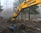 Excavator using universal attachment for log grapples and buckets from grapplepros.com